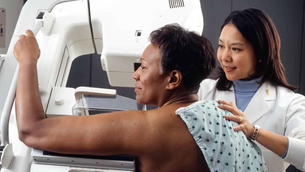 woman receives mammogram